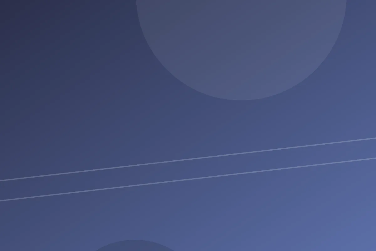 wind turbines turning across green hills under a clear sky